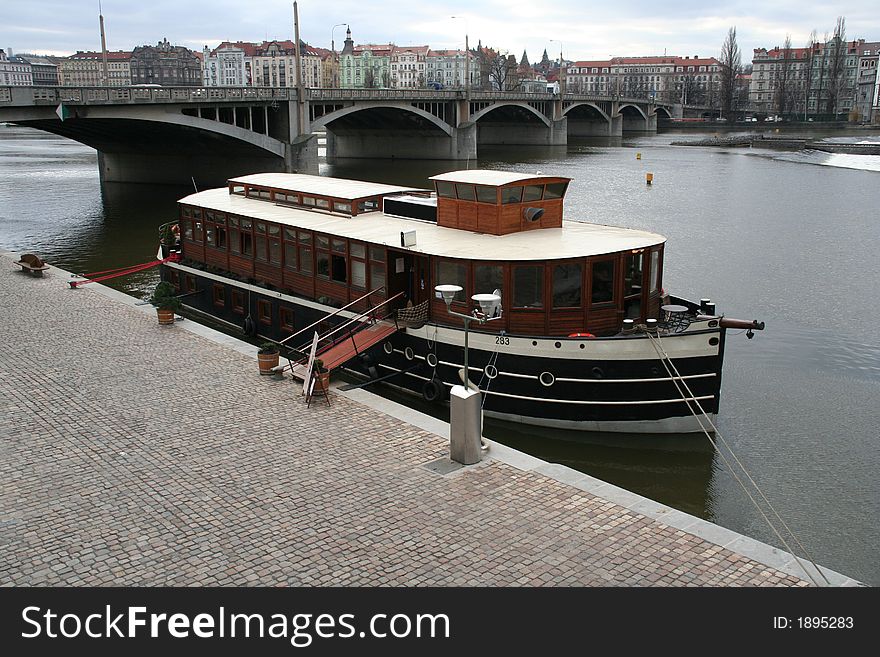 A big boat on Vltava river near the pier. A big boat on Vltava river near the pier