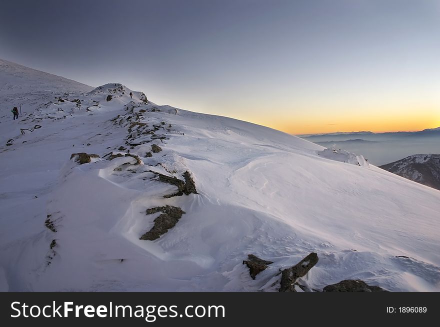 Mountaineers on the ridge, watching sunrise