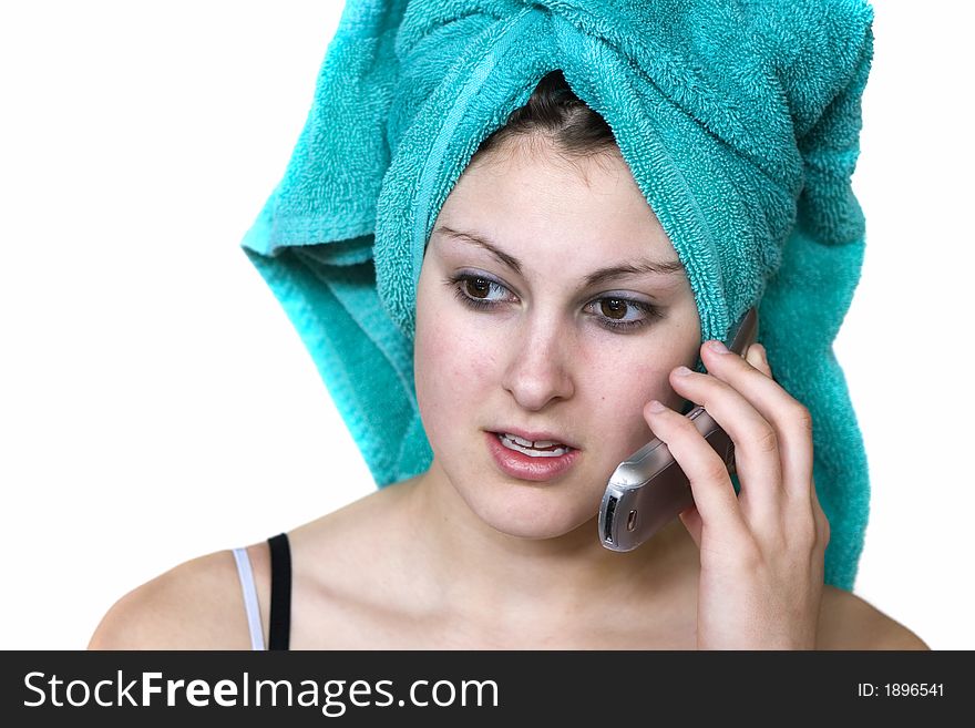 Natural teen talking on the phone with a towel on her head