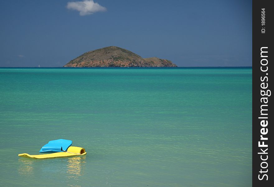 Drifting air beds in a blue caribbean lagoon. Drifting air beds in a blue caribbean lagoon
