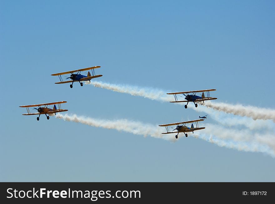 Four Aircraft in formation with smoke on. Four Aircraft in formation with smoke on