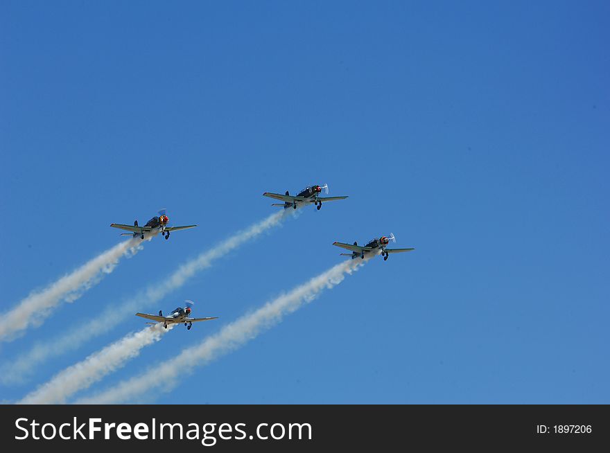 Russian Yakovlev Aircraft flying in formation at an Airshow. Russian Yakovlev Aircraft flying in formation at an Airshow