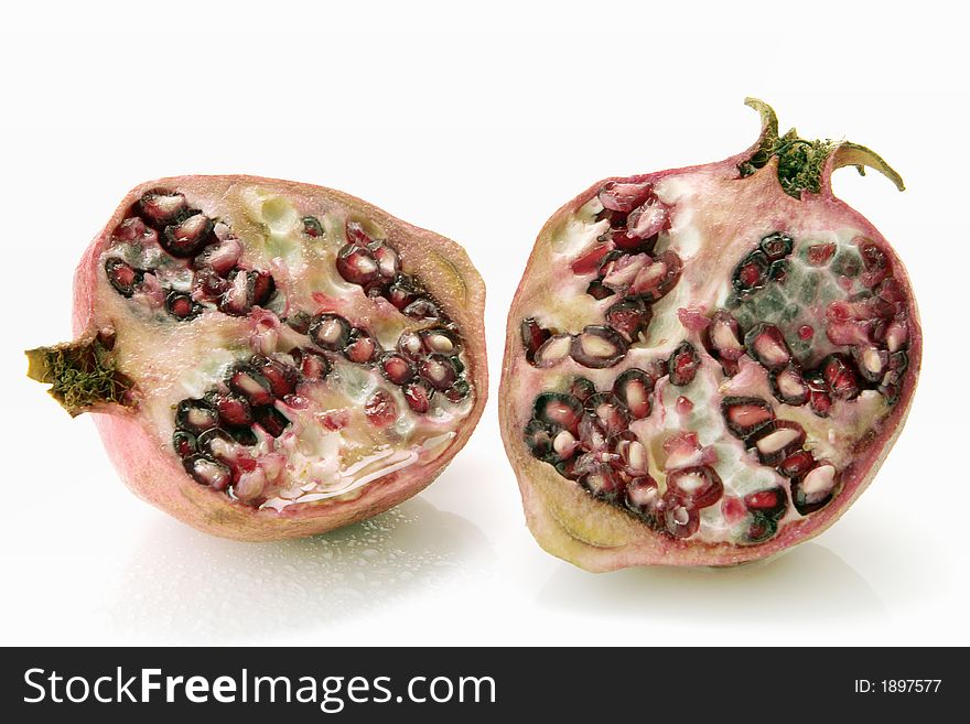 Freshly sliced pomegranate over white background