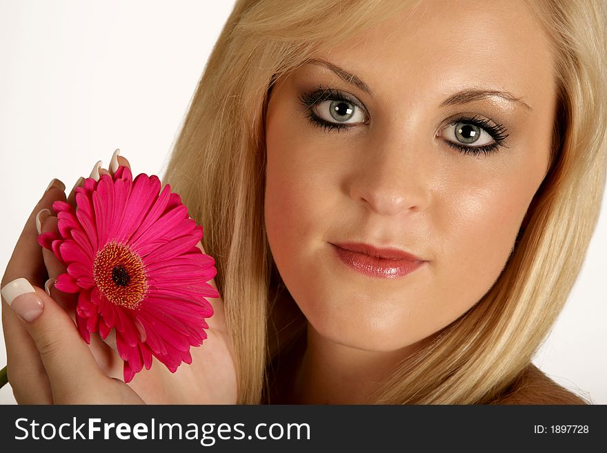 A woman holding a daisy in her hands. A woman holding a daisy in her hands