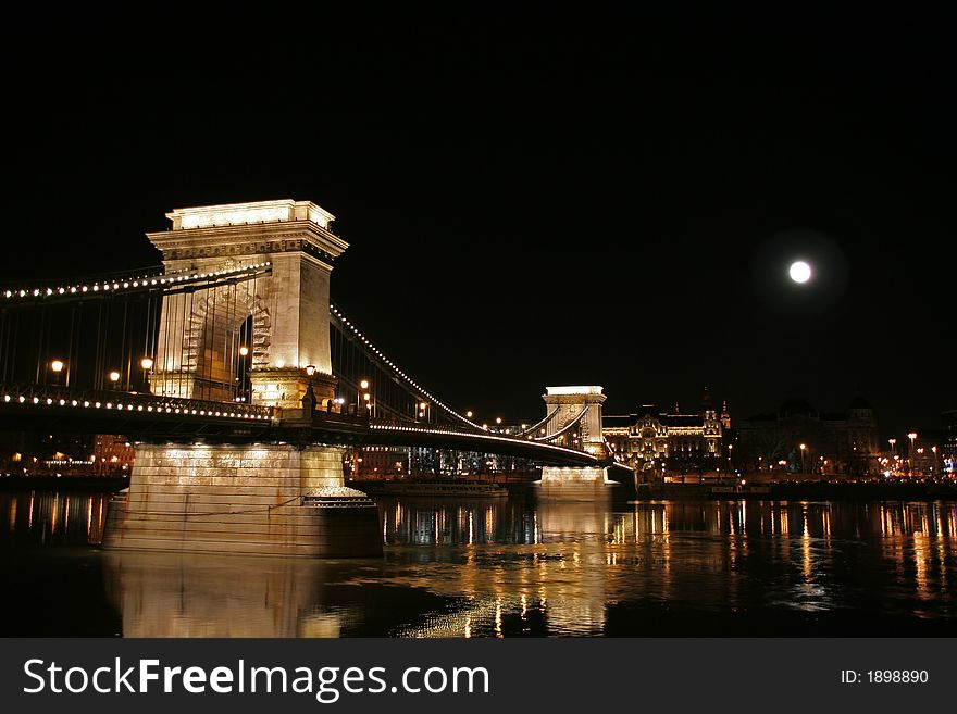 Szechenyi Chain Bridge connecting Buda and Pest sides of the Hungarian capital Budapest at full moon