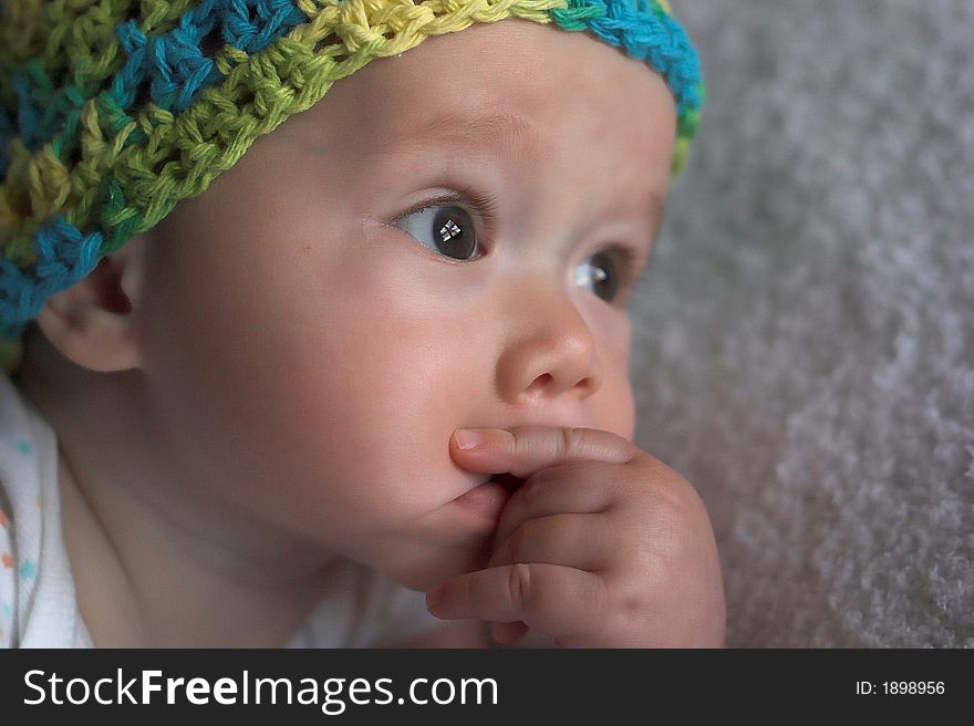 Image of a cute baby wearing a crochet cap. Image of a cute baby wearing a crochet cap