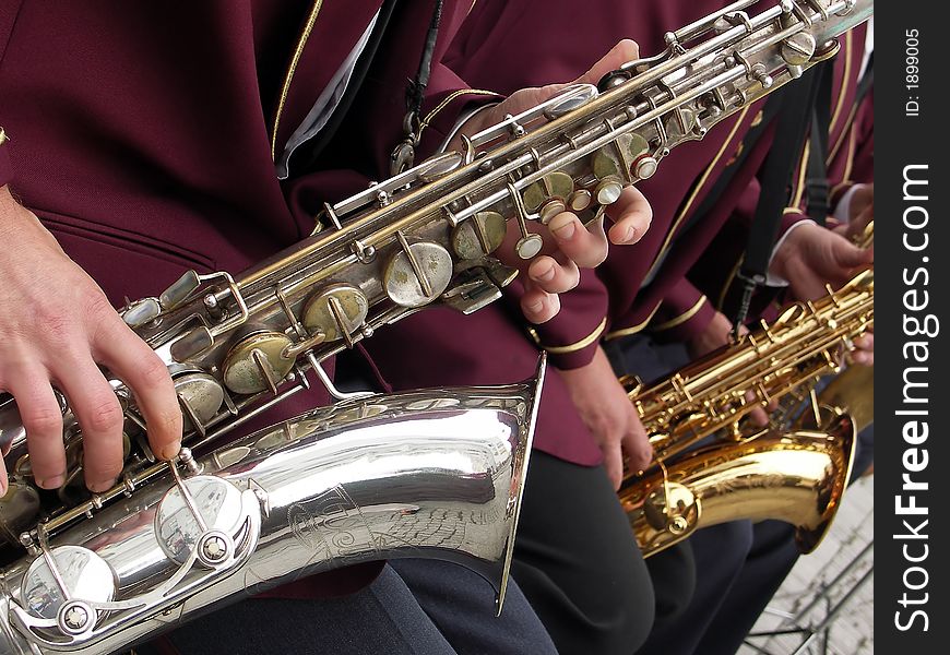 Close - up man hands playing saxophone