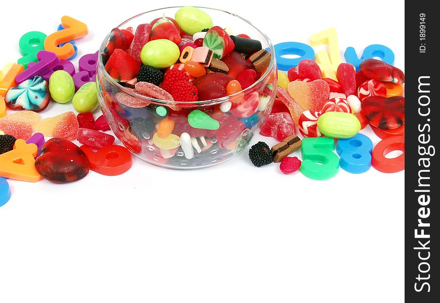 Colorful pastel candy and play numbers on glass bowl with blank space for copy. Colorful pastel candy and play numbers on glass bowl with blank space for copy