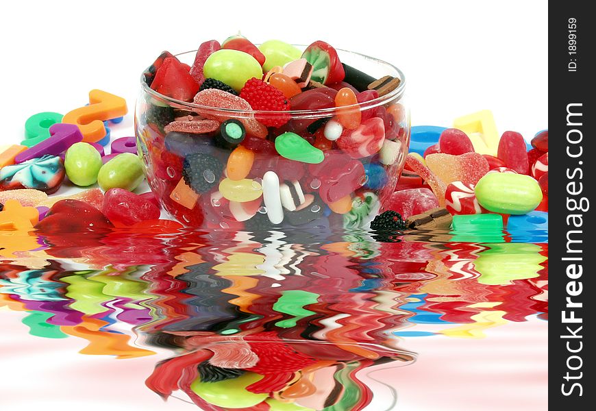 Colorful pastel candy and play numbers on glass bowl. Colorful pastel candy and play numbers on glass bowl