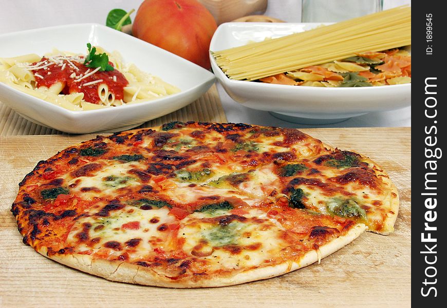 Products of italian cucine with macaronni on tomato sauce and tasty pizza