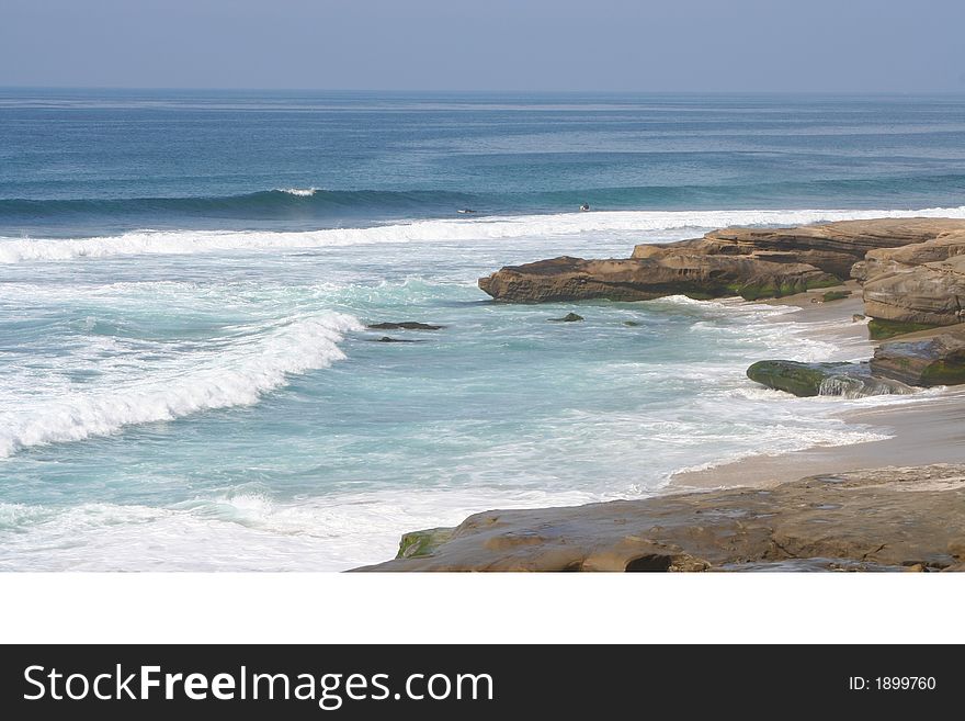 This is a picture of the shoreline at Windandsea Beach with a glimpse of rocks and surfers. This is a picture of the shoreline at Windandsea Beach with a glimpse of rocks and surfers.