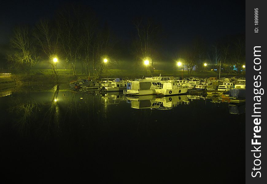 Boats on Belgrade river Sava, near lake, during the night. Image is taken from hand, during very warm winter season. Boats on Belgrade river Sava, near lake, during the night. Image is taken from hand, during very warm winter season.