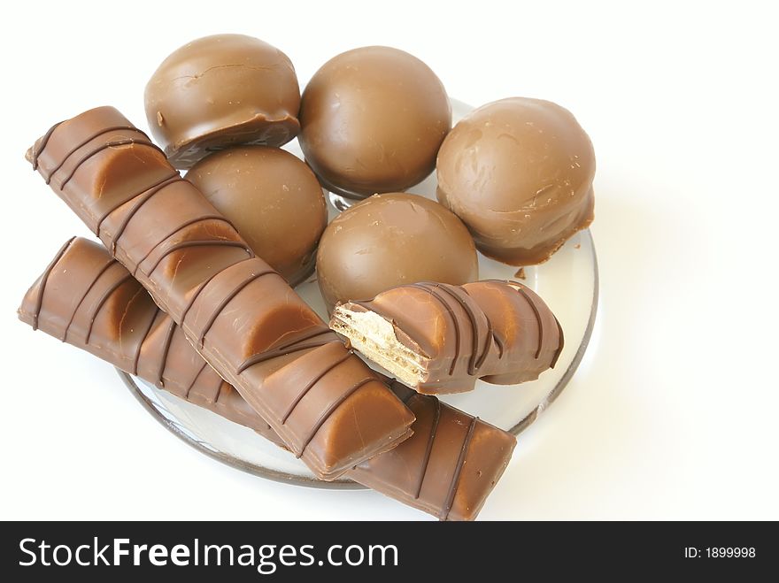 Tasty chocolate candies close-up isolated on white.