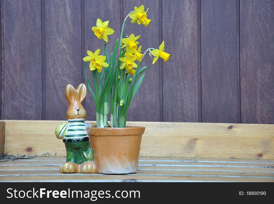 Easterbunny with flowerpot and daffodills. Easterbunny with flowerpot and daffodills
