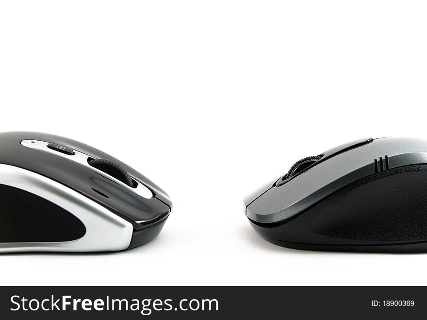 Two computer mouse of dark blue color on a white background