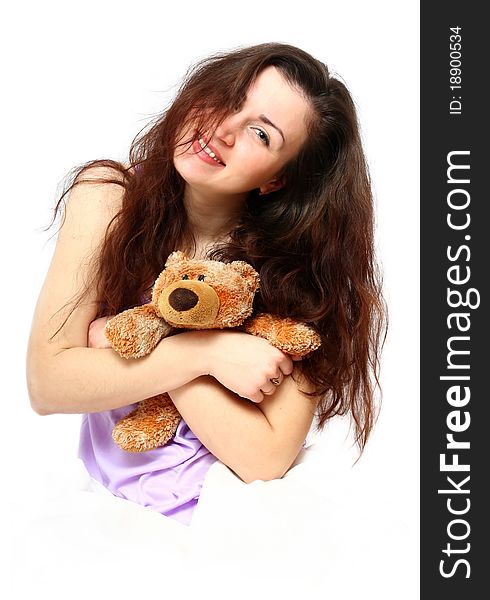 Morning portrait of a beautiful young girl with a bear