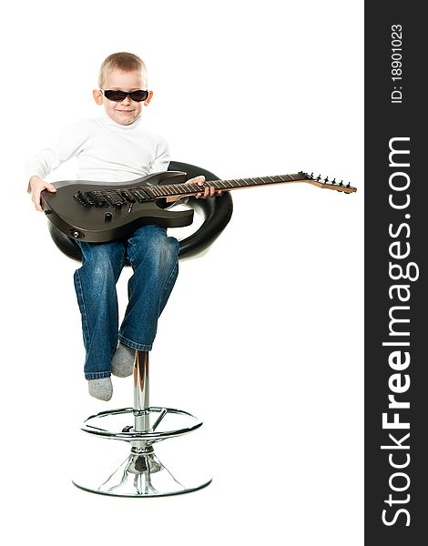 Cute little boy holding a guitar isolated on white