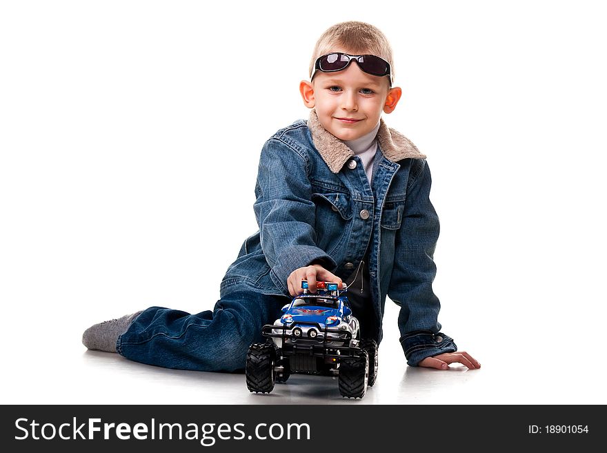 Cute little boy playing with car isolated on white