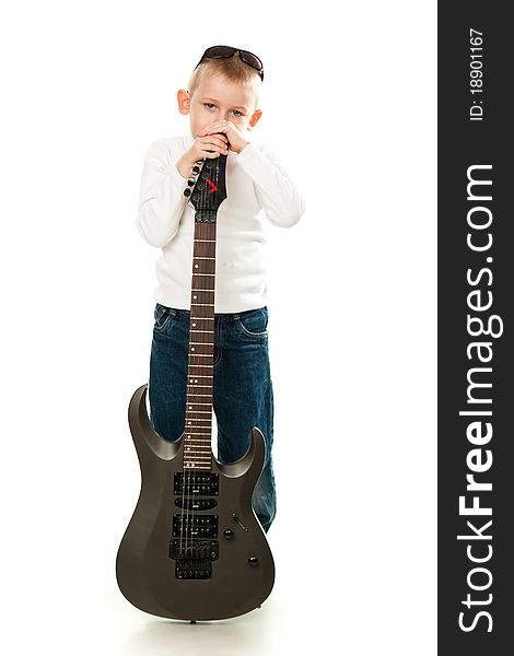 Cute little boy holding a guitar isolated on white