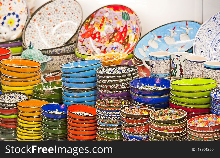 Decorated ottoman style ceramic plates and bowls in a turkish market stall. Decorated ottoman style ceramic plates and bowls in a turkish market stall