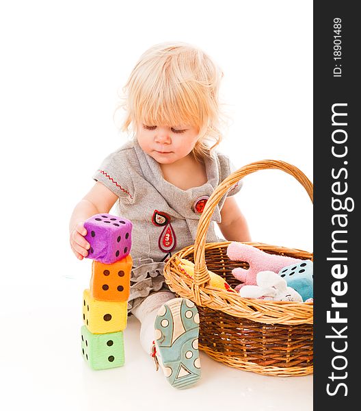 Little blonde haired girl playing with toys. Little blonde haired girl playing with toys