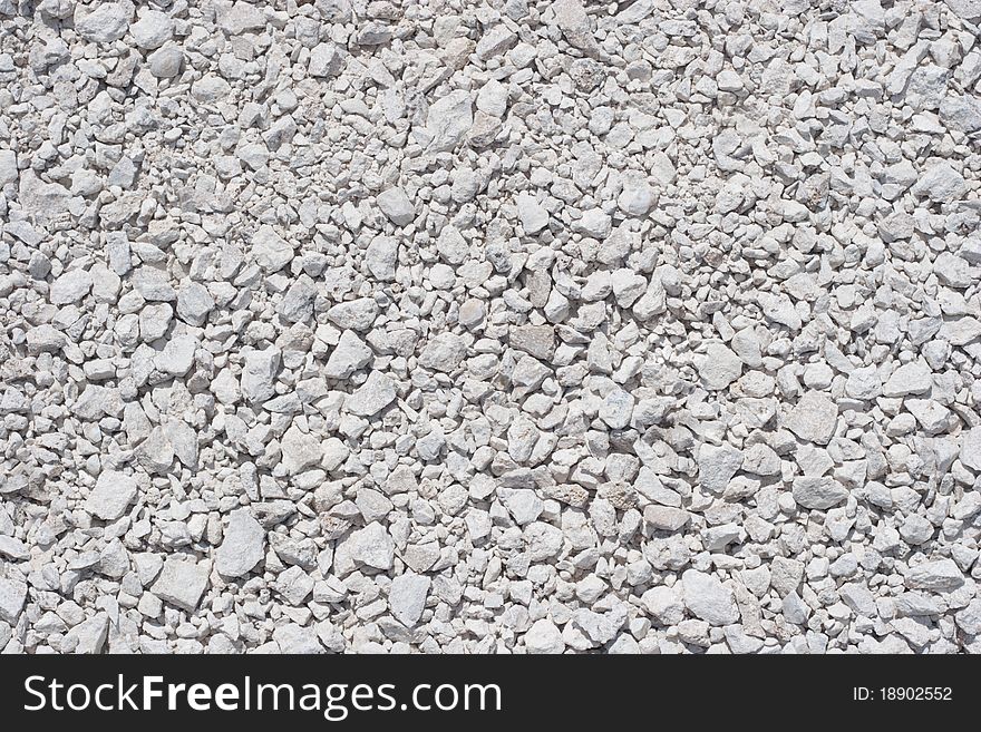 Grayish-white gravels, filling up the whole frame. Grayish-white gravels, filling up the whole frame