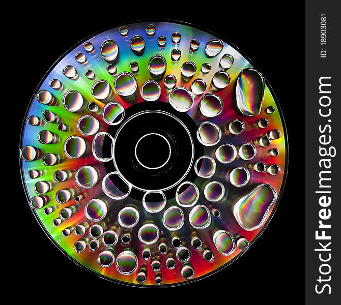 Compact Disc CD with water drops on the data surface with a shiny colorful reflection. Compact Disc CD with water drops on the data surface with a shiny colorful reflection