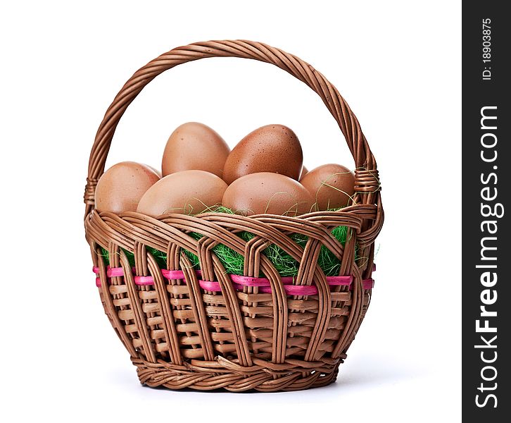 Woven basket full of eggs. Isolated on a white background. Woven basket full of eggs. Isolated on a white background.