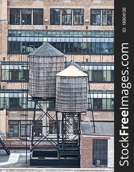 Cropped view of buildings in New York City and rooftop water towers. Cropped view of buildings in New York City and rooftop water towers.