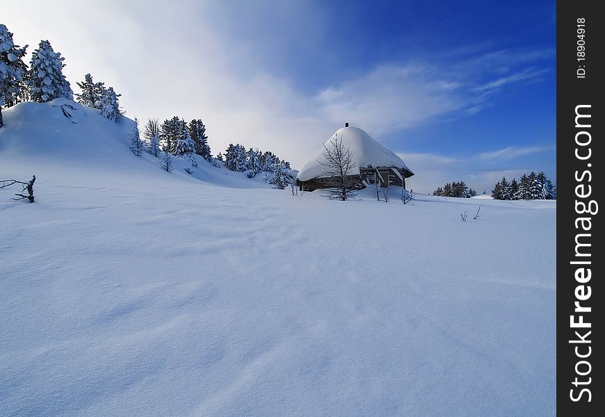 Hut in the mountains in the snow