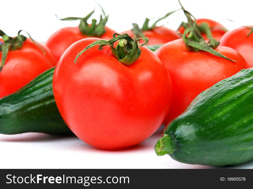 Tomatoes and cucumbers isolated on the white