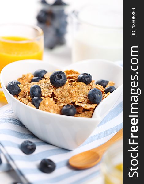 Healthy breakfast- cereal with fresh blueberries, juice and milk