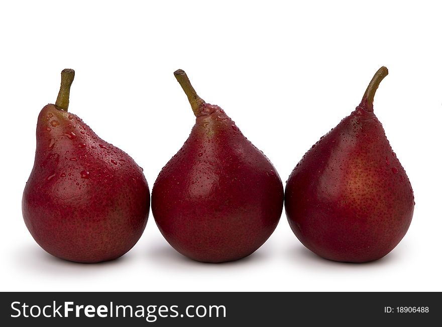 Three red pears isolated on white background with water drops
