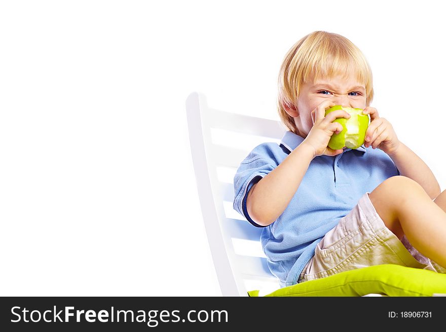 Little boy on chair with apple isolated over white background. Little boy on chair with apple isolated over white background