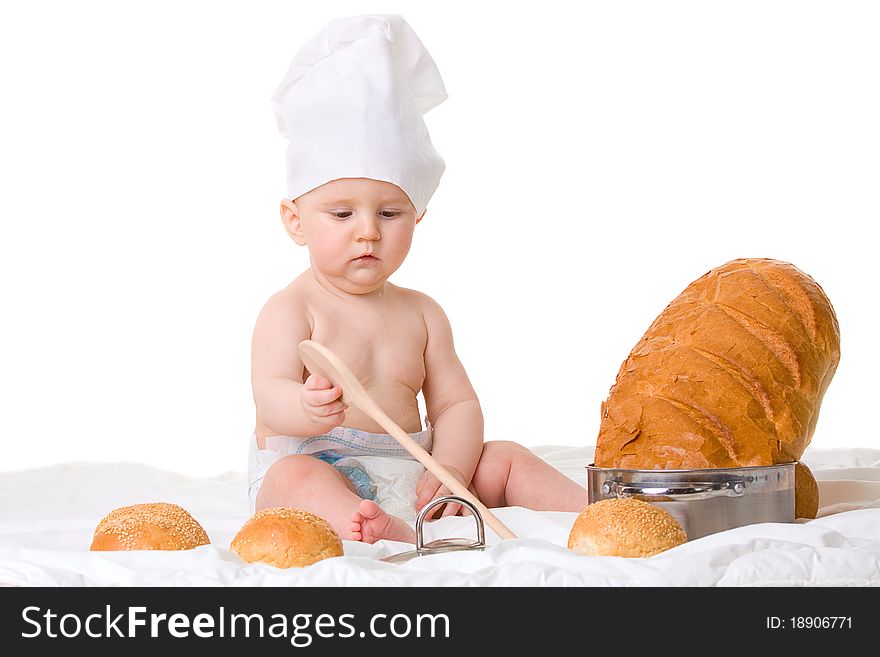 Little boy chef with spoon and bread