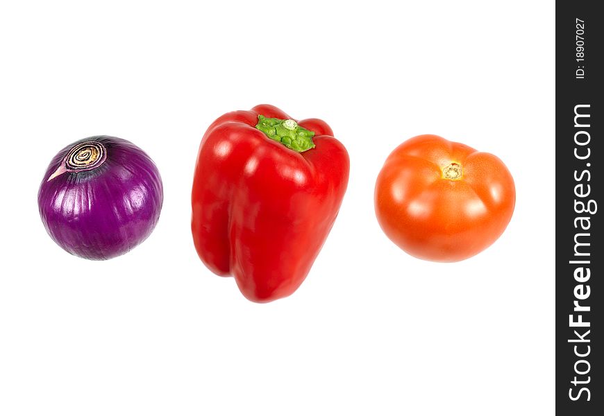 A red onion, capsicum and tomato isolated against a white background. A red onion, capsicum and tomato isolated against a white background