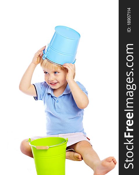 Little cute boy holding green and blue buckets isolated over white background. Little cute boy holding green and blue buckets isolated over white background