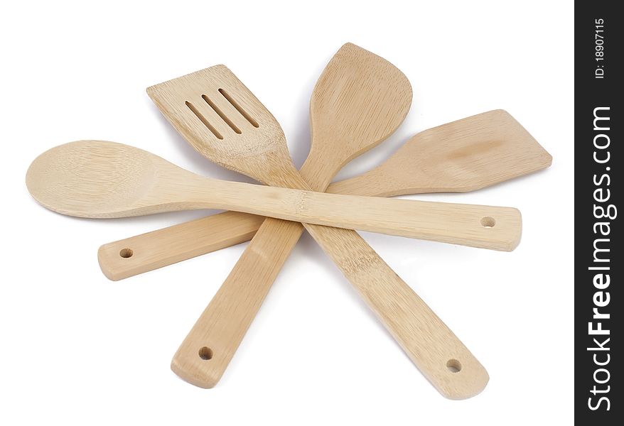 Kitchen accessories (spatulas and a spoon) from a bamboo on a white background. Kitchen accessories (spatulas and a spoon) from a bamboo on a white background.