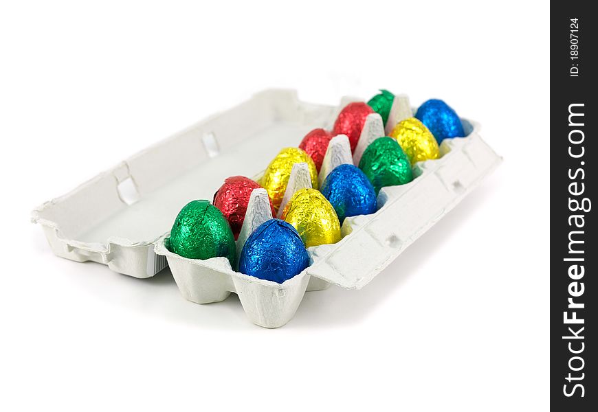 Chocolate Easter eggs in an egg carton isolated against a white background