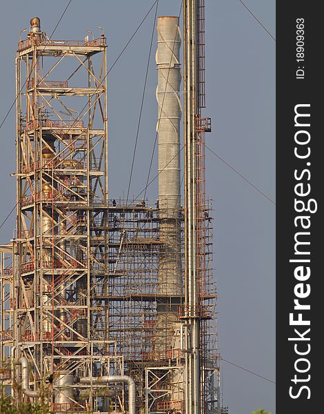 The oil refinery construct on blue sky background