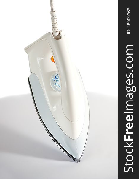 Electronic iron on grey table and white background