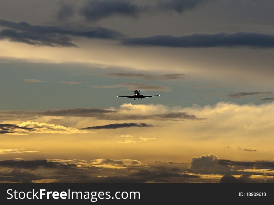 Aircraft in final approach to airport at dusk