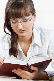 Beautiful Girl Thoughtfully Reading A Book Royalty Free Stock Photo