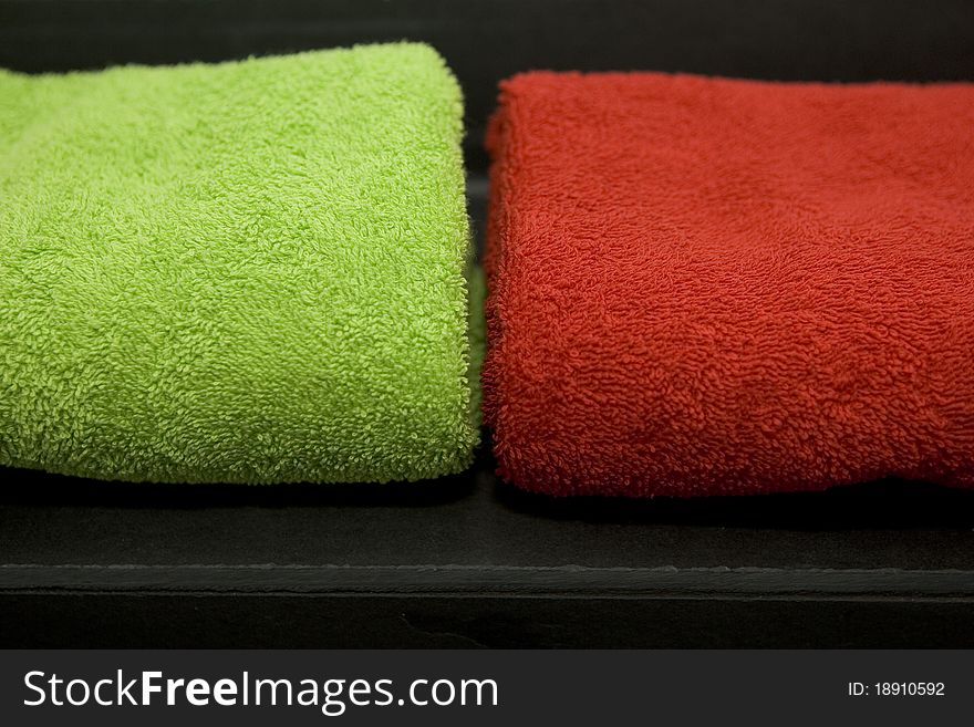 These are two colorful towels on a slate plate