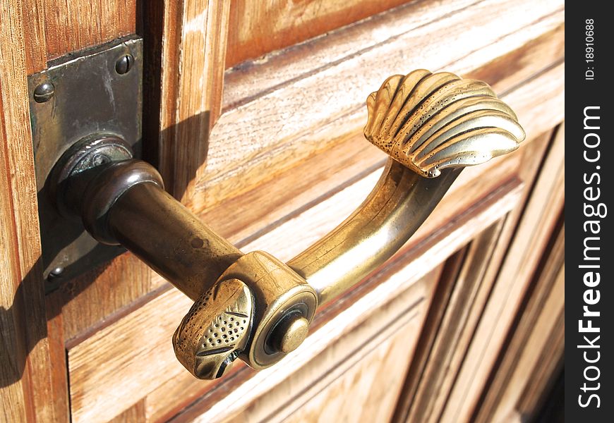 An old door handle on a wooden door
