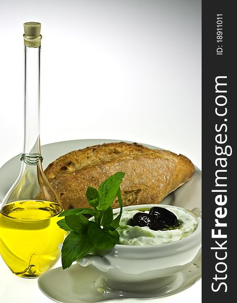 Traditional Greek dip tzatziki, olive oil and bread roll