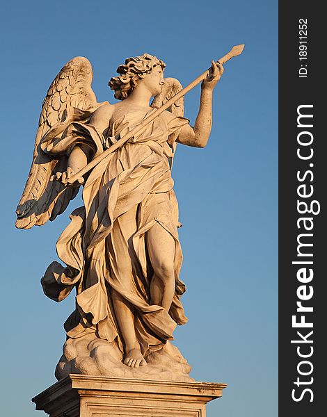 Angel with spear lit by sunset sun, Ponte Sant'Angelo bridge, Rome