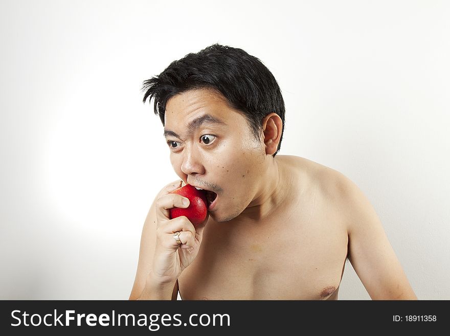 Biting apple, A man bite an apple very hard.