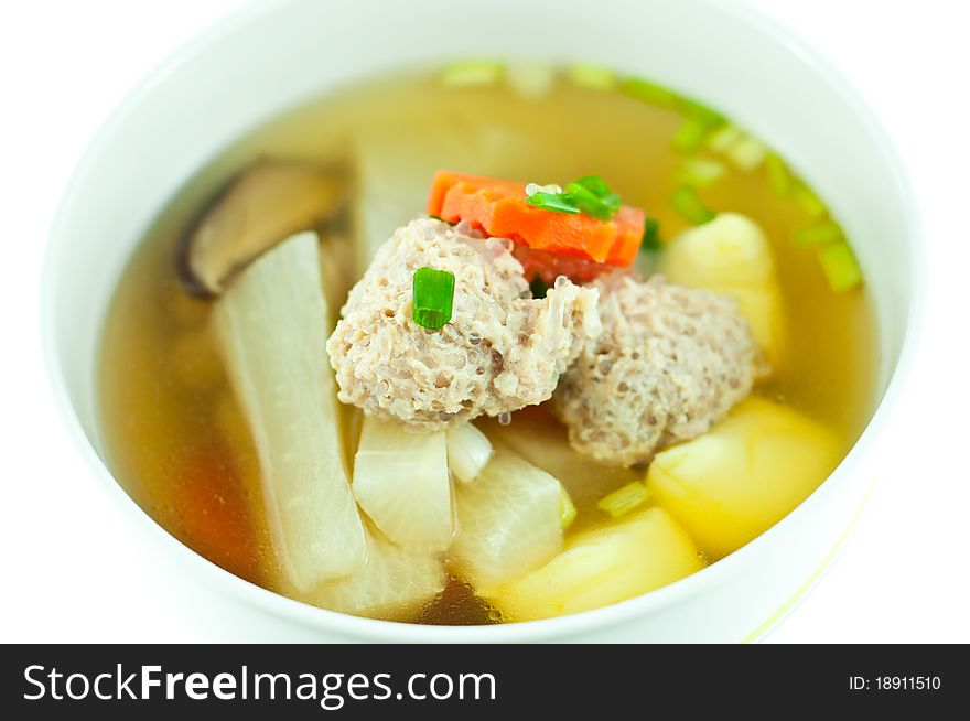 Vegetable soup with pork in white bowl