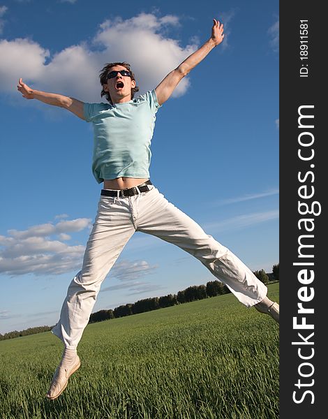 Young man is jumping outdoors